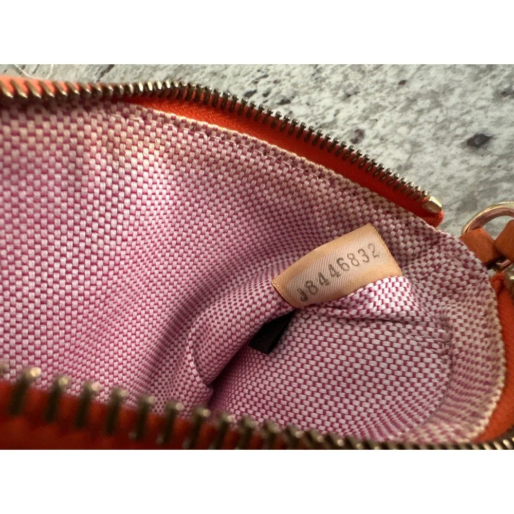 Dooney & Bourke pebble grain large slim wristlet bag in orange